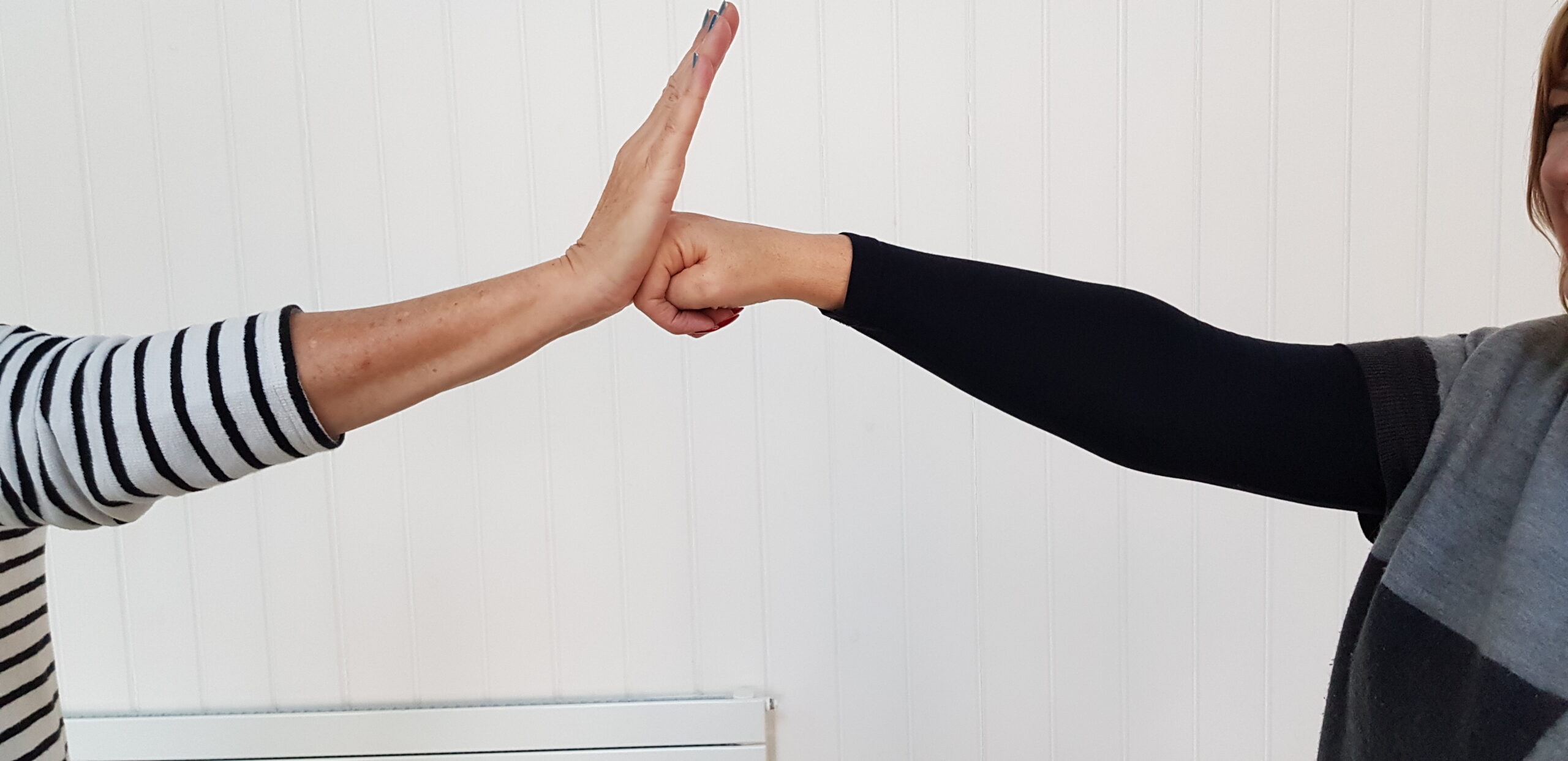 Two participants exploring pressure and boundaries with their hands